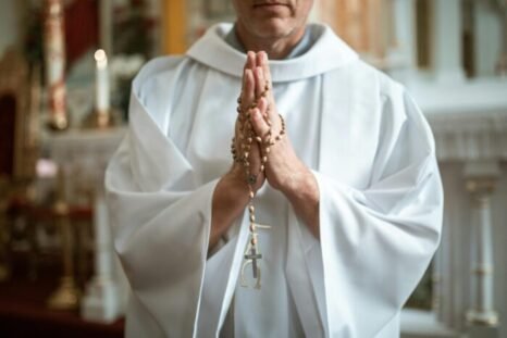 priest praying